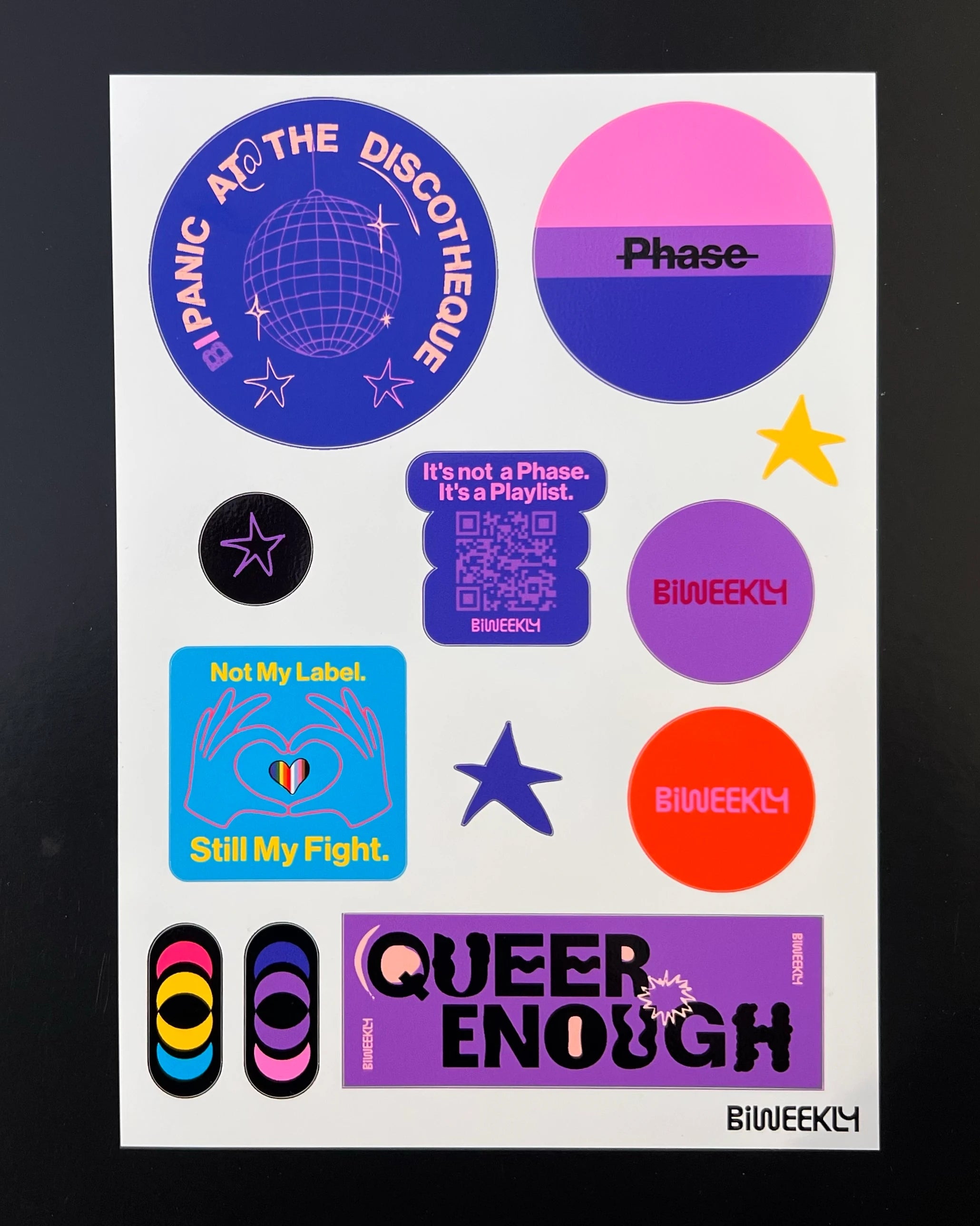 Stickersheet with 12 queer-coded stickers in colors of the bi and pan flag and beige, coral and burgundy on black background