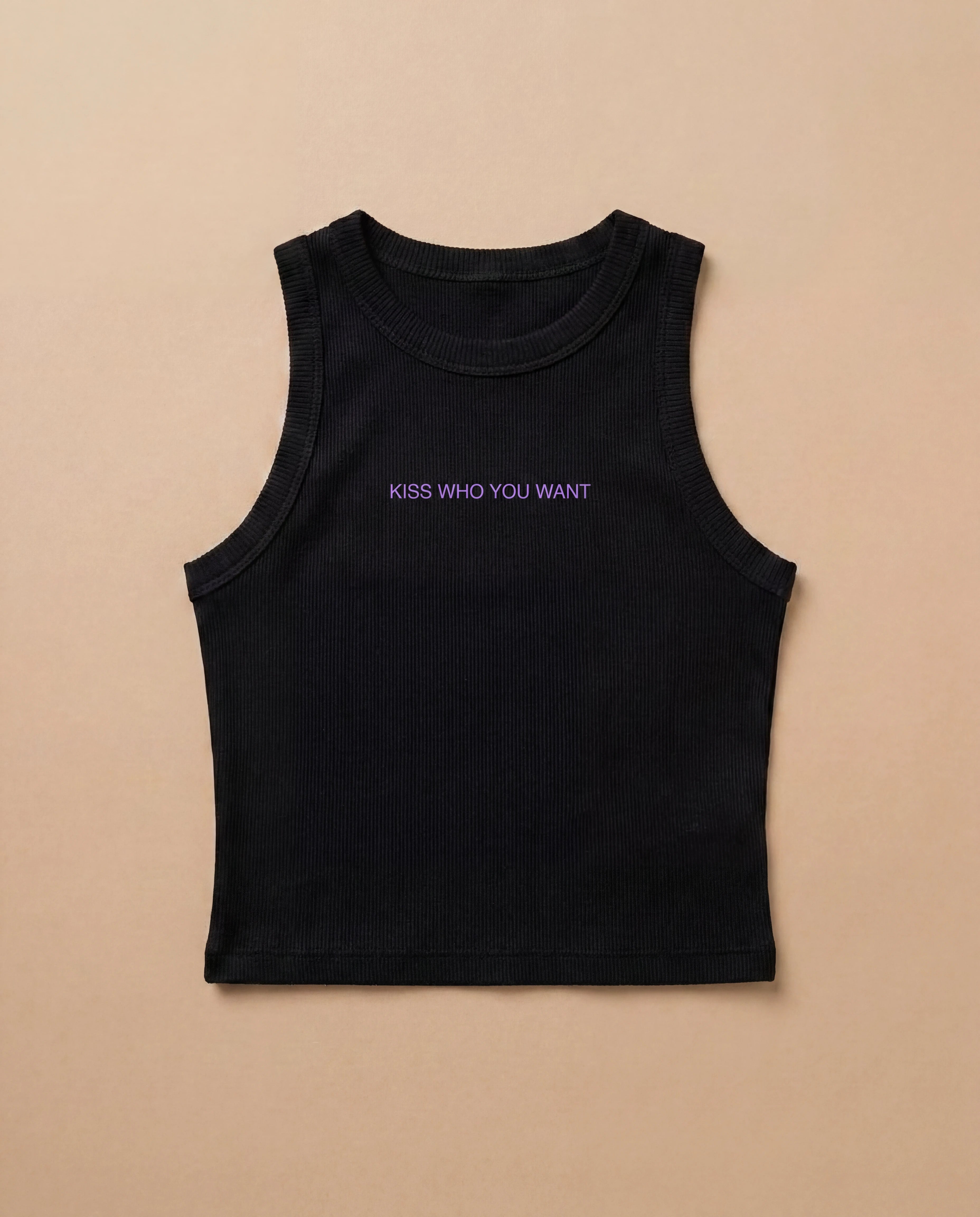 Black Biweekly tank top with lilac ‘Kiss Who You Want’ text, laying flat against a beige background