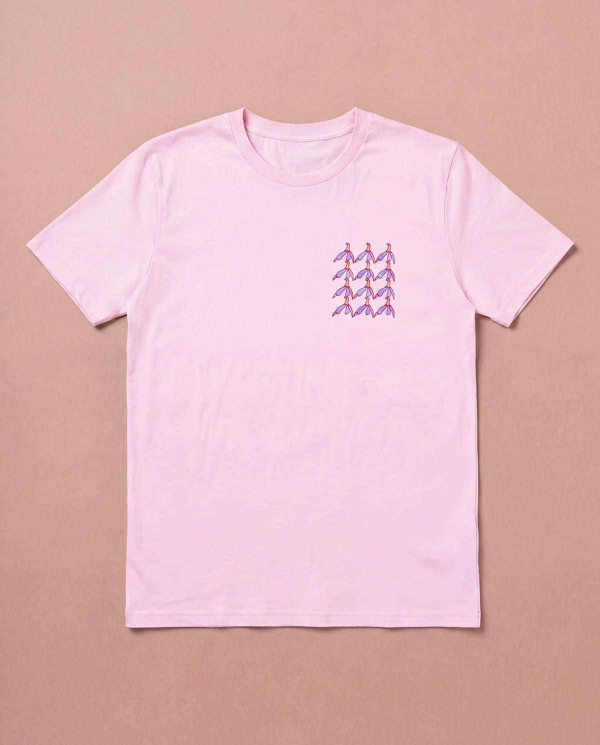 Light pink Biweekly T-shirt with clit graphic print on right chest area, front view, laying flat on a beige background