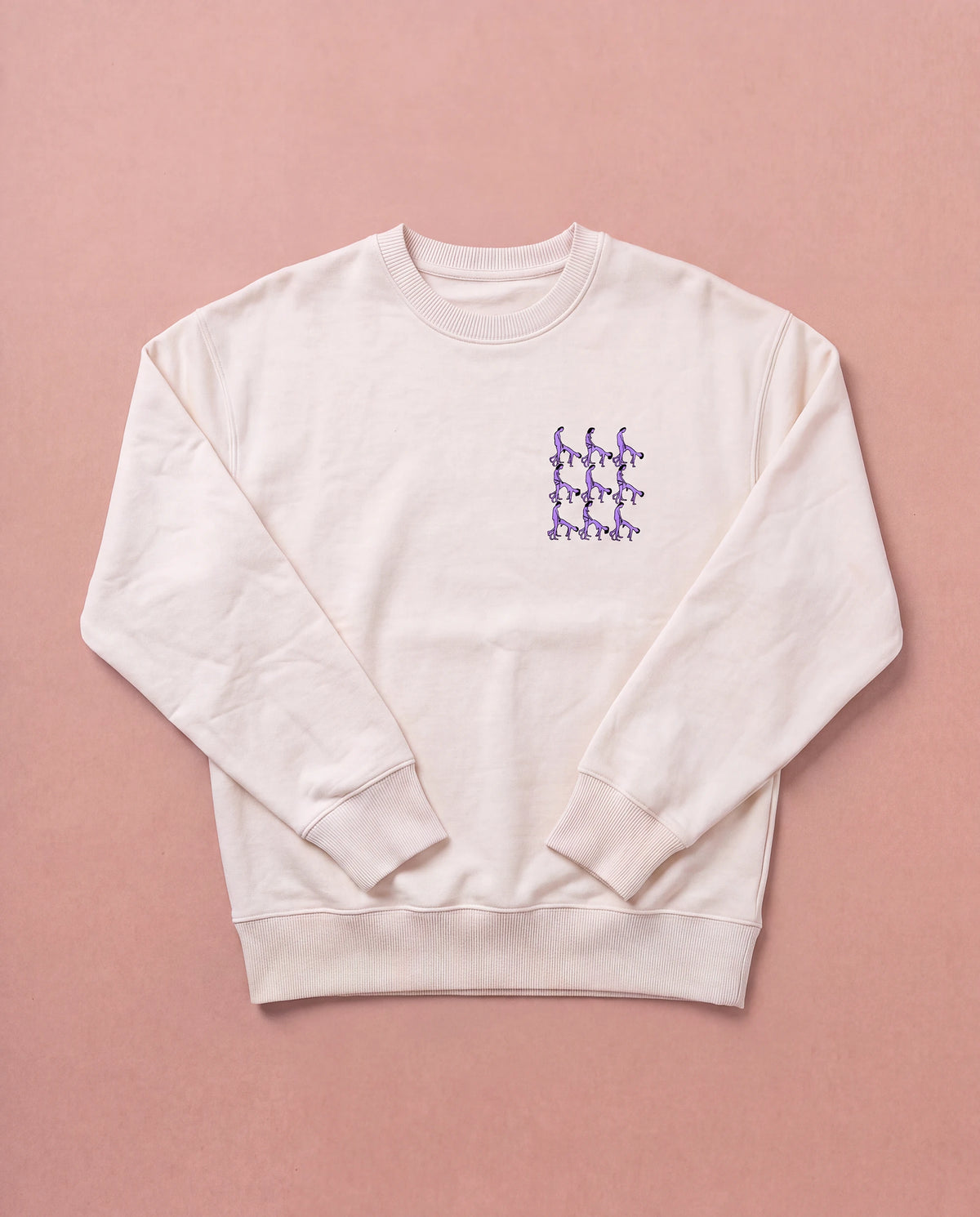 Beige Biweekly crewneck with lilac playful spicy graphic print on right chest area, front view, laying flat on a beige background