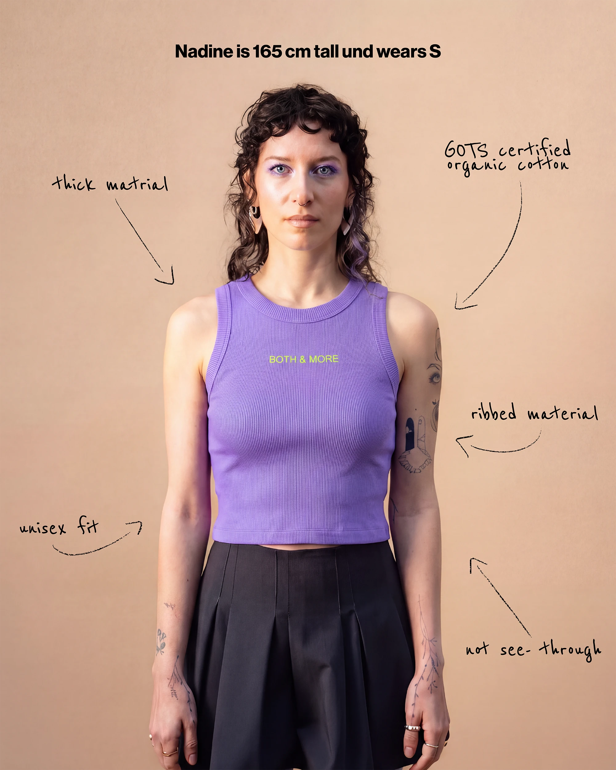 Model wearing a lilac Biweekly tank top with yellow ‘BOTH & MORE’ text, front view against a beige background. Text that gives information about the top.