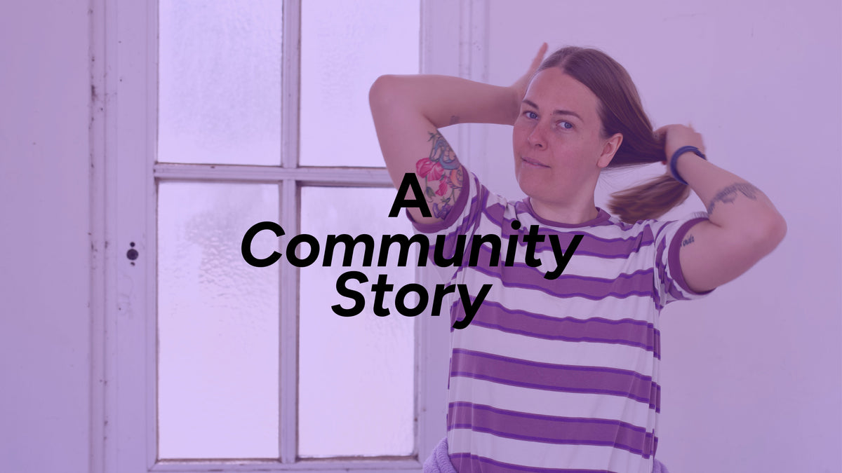 Woman posing before a white background with a window, author of the article, lilac semitransparent overlay and text "A Community Story" 
