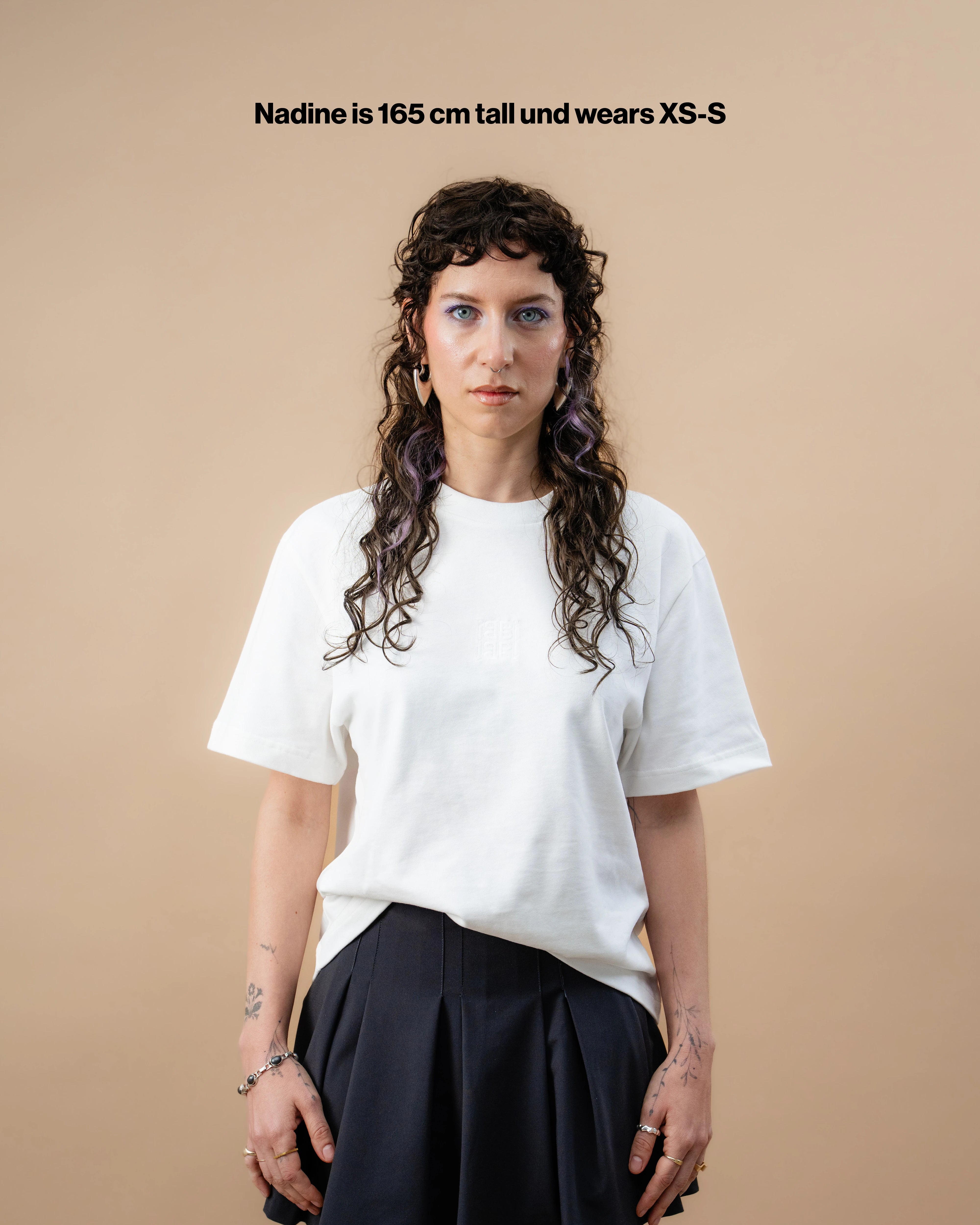 Model wearing a white Biweekly oversized tee, front view against a beige background with the text "Nadine is 165cm tall and wears XS-S"