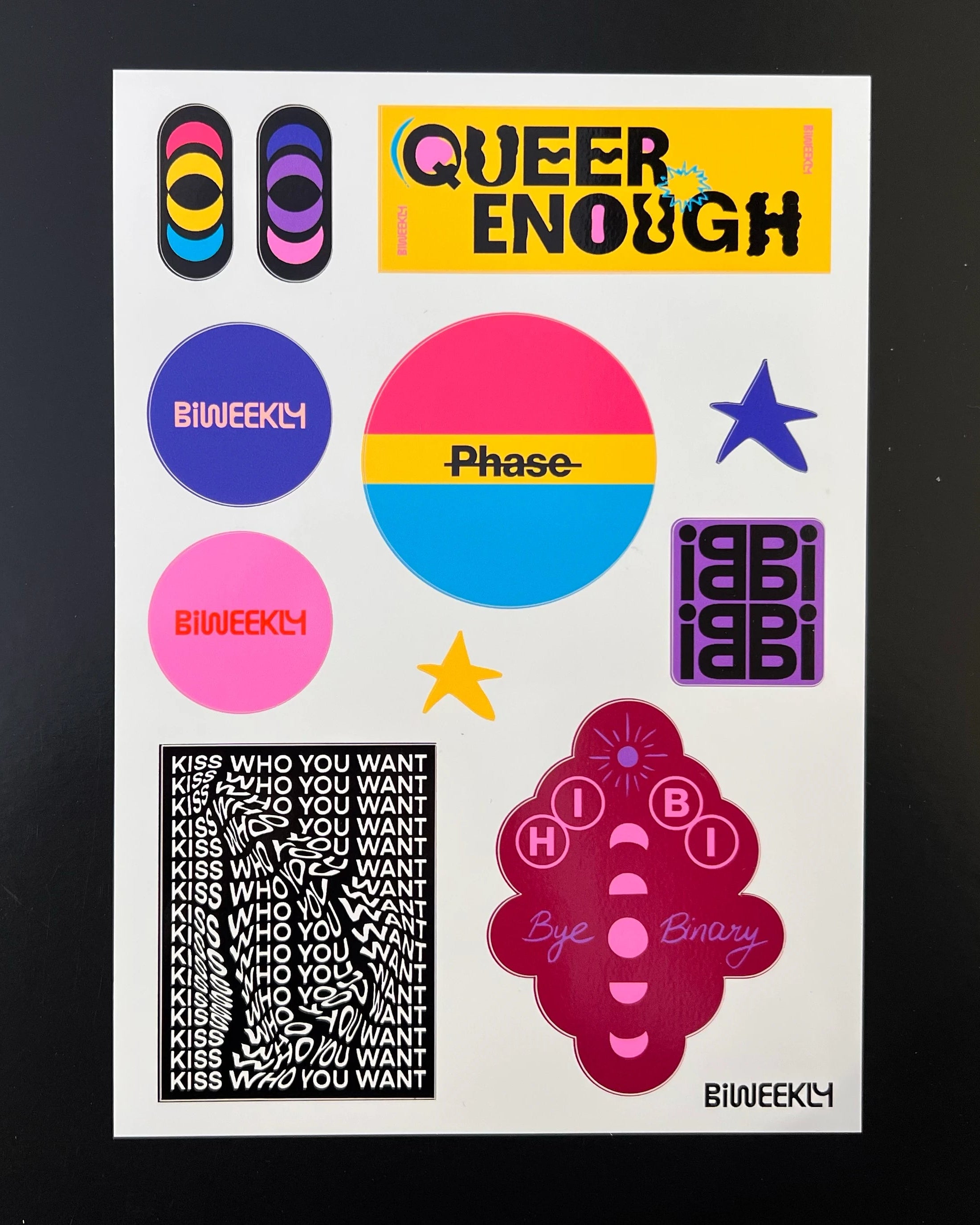 Stickersheet with 11 queer-coded stickers in colors of the bi and pan flag and beige, coral and burgundy on black background