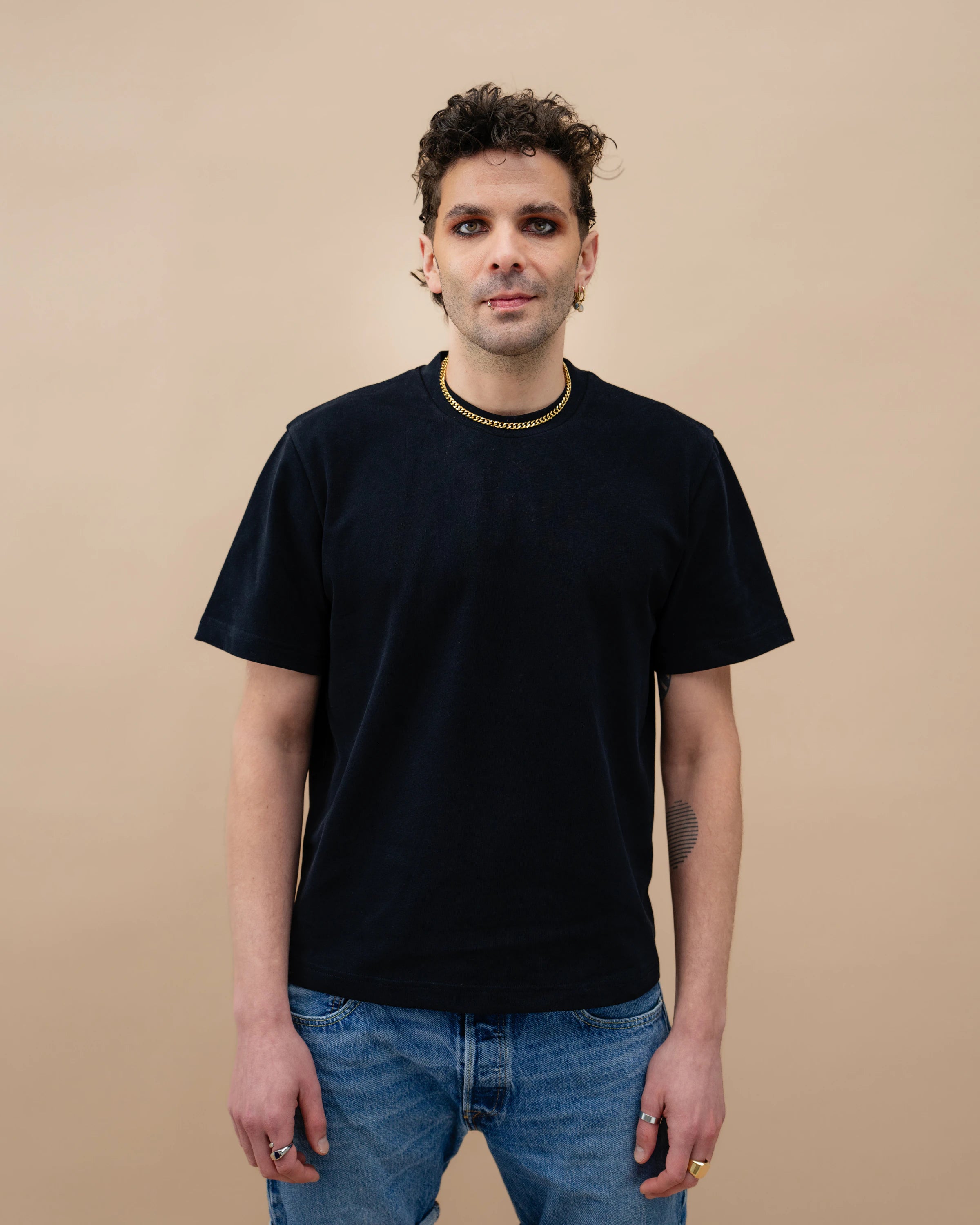 Model wearing a black oversized Biweekly T-shirt with black ‘BiBi’ logo, front view against a beige background