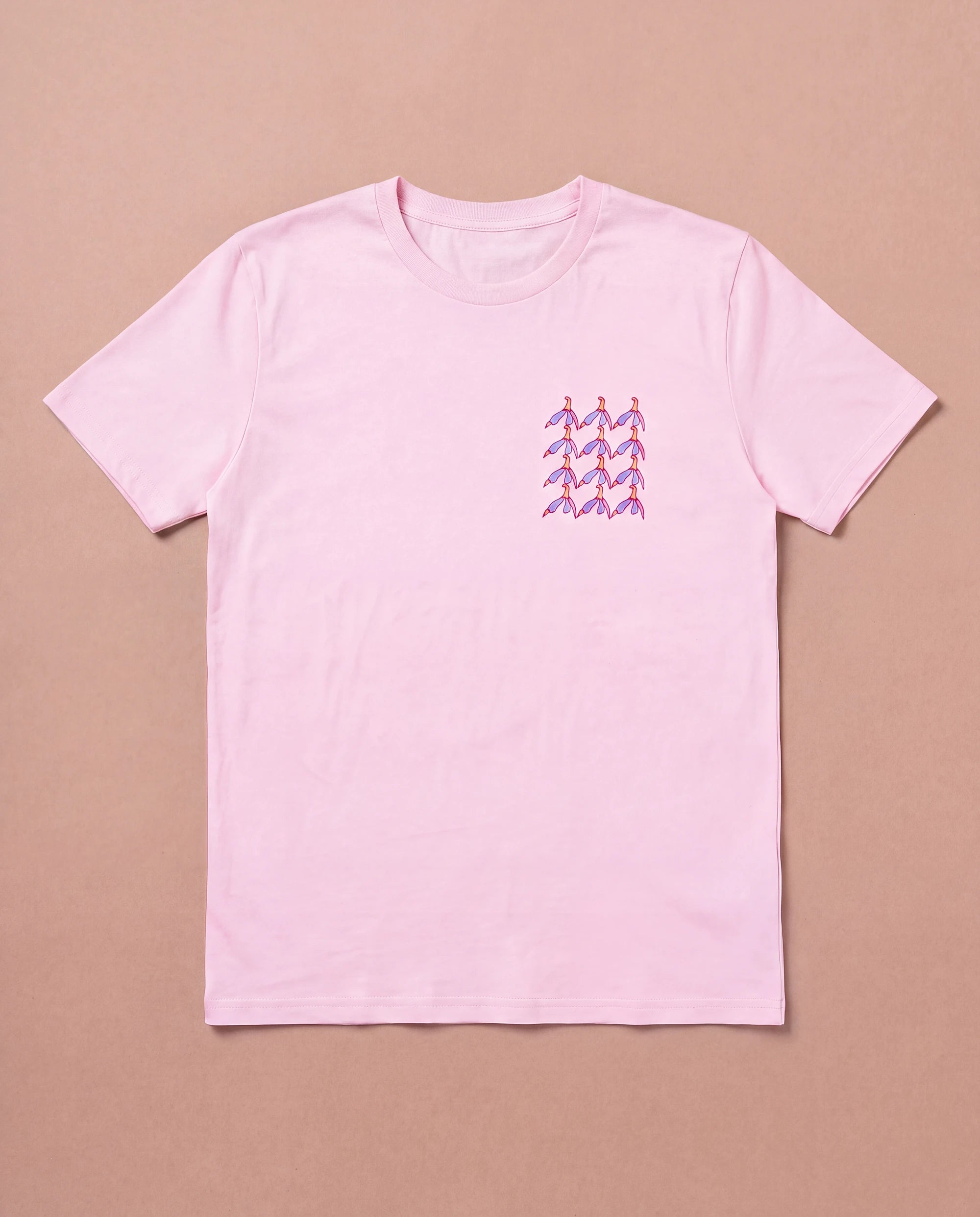 Light pink Biweekly T-shirt with clit graphic print on right chest area, front view, laying flat on a beige background