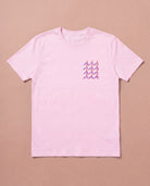 Light pink Biweekly T-shirt with clit graphic print on right chest area, front view, laying flat on a beige background