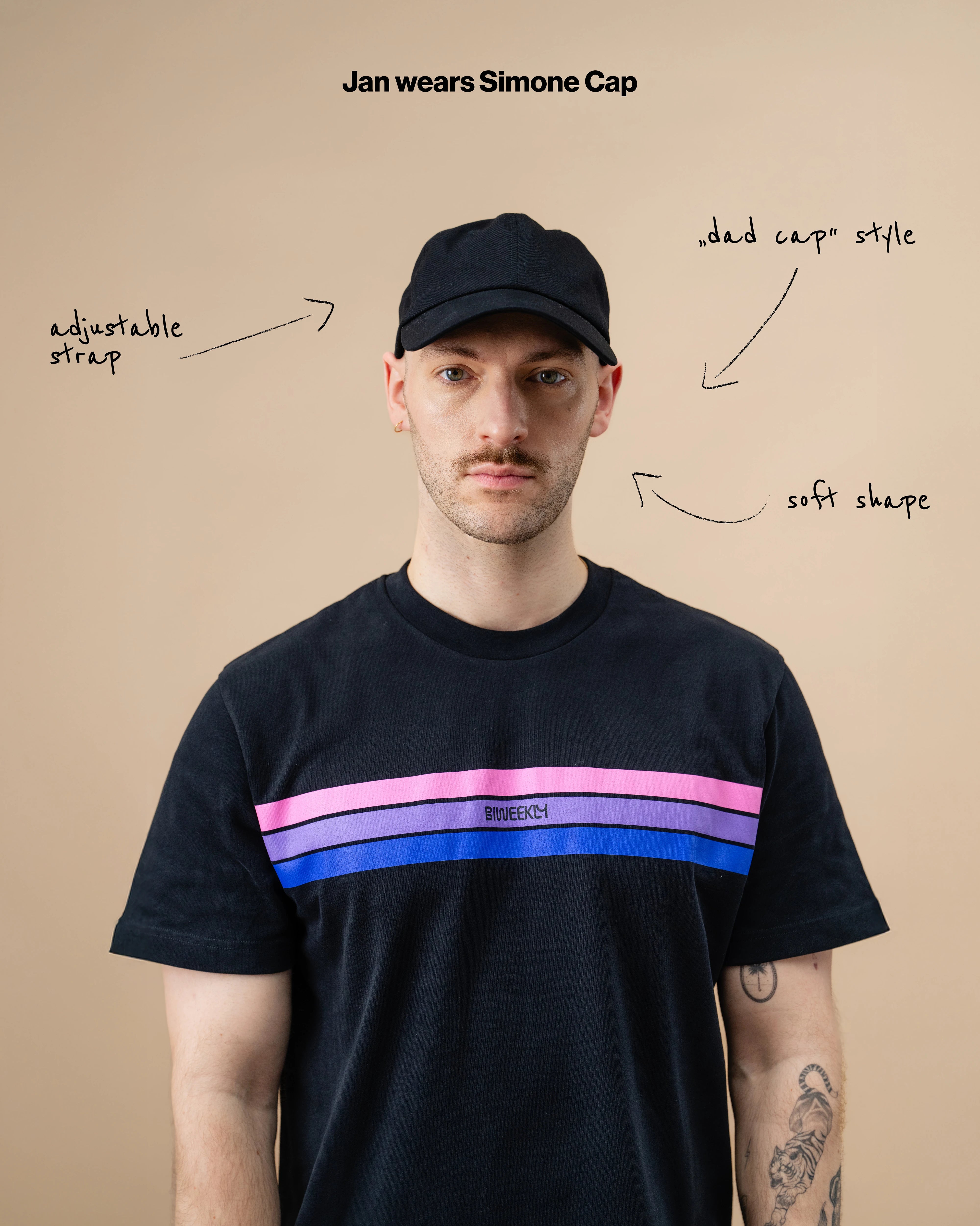 Model wearing a black Biweekly cap against a beige background with text: "adjustable straps, dad cap style, soft shape" arranged with arrows