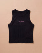 Black Biweekly tank top with pink ‘bi panic’ text, laying flat against a beige background