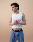 Model wears Biweekly keychain in bi pride flag colors with silver carabiner and blue yarn on his belt loop against beige background