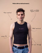Model wearing a black Biweekly tank top with pink ‘bi panic’ text, front view against a beige background. Text that gives information about top. 