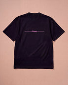 Oversized black Biweekly T-shirt with pink text 'Phase' crossed out by a long line, laying flat a beige background