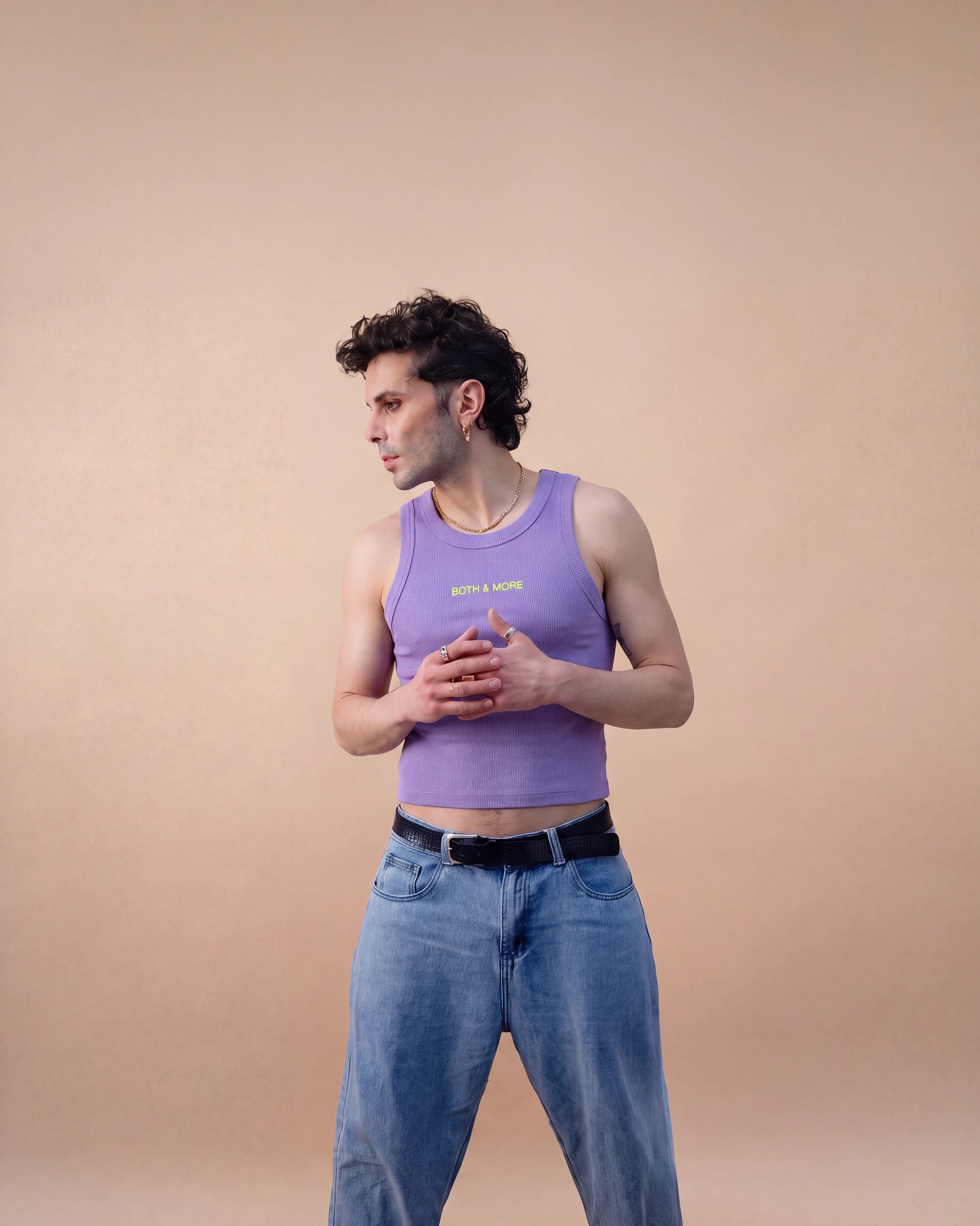 Model wearing a lilac Biweekly tank top with a yellow ‘BOTH & MORE’ text that is crossed out, full body shot front view against a beige background