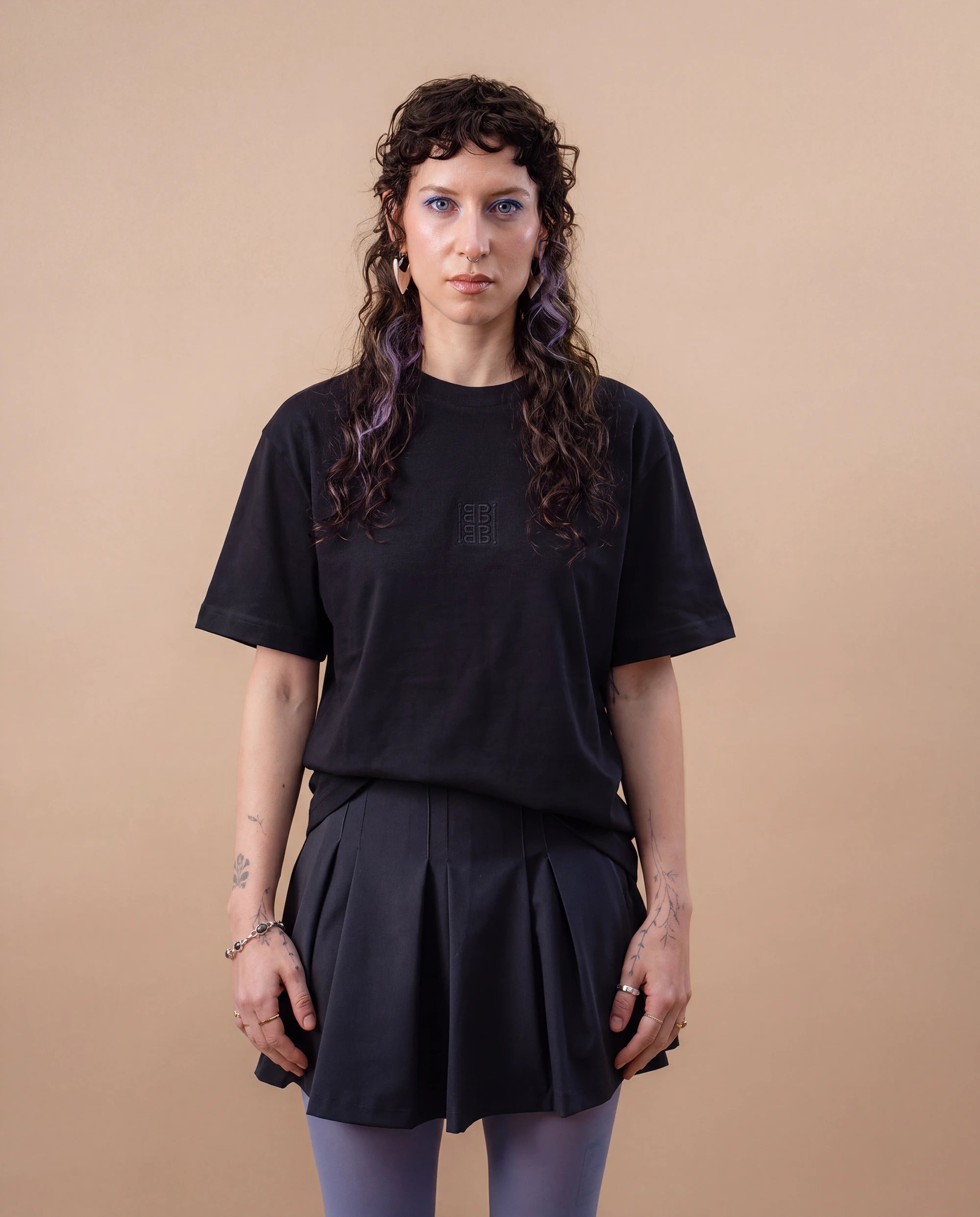 Model wears an oversized black Biweekly T-shirt with black ‘BiBi’ logo, front view against a beige background